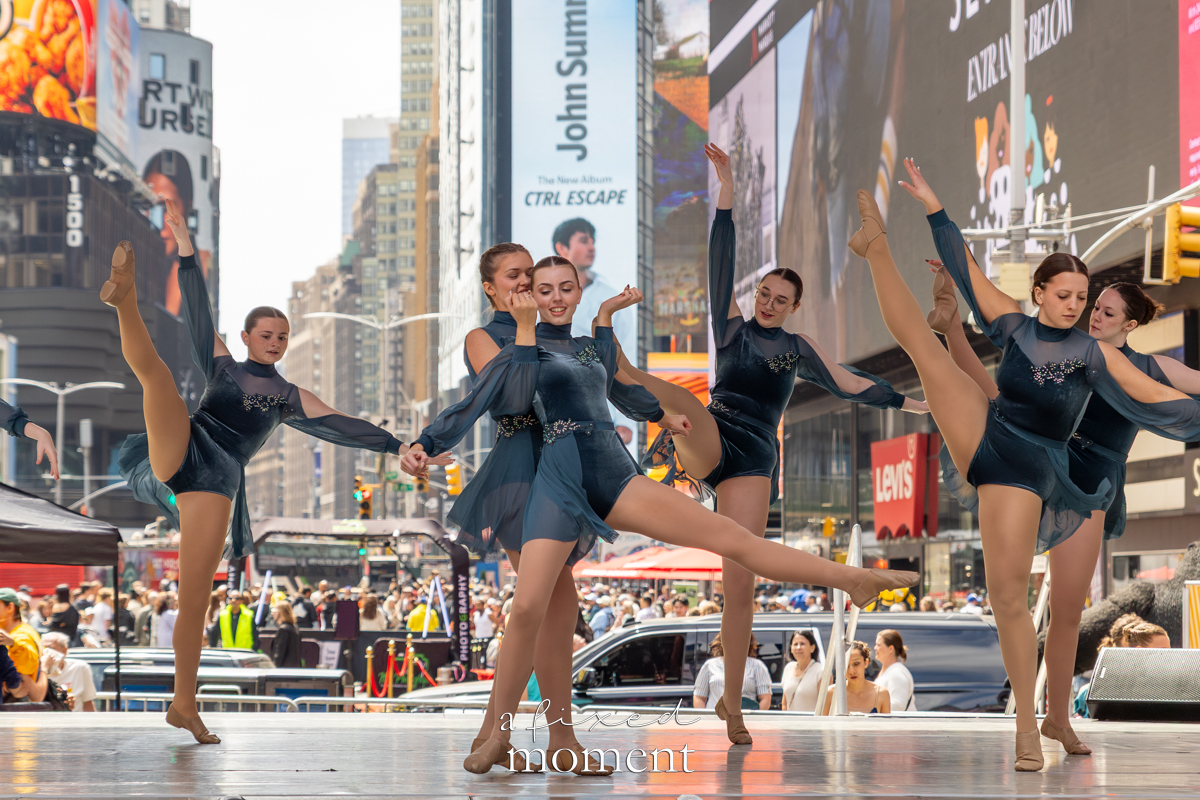 Project Dance dancers in green costumes high kicks