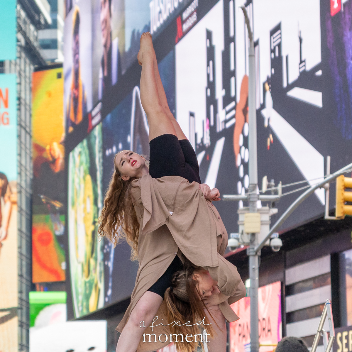 Project Dance dancer performs an inverted lift extension on stage