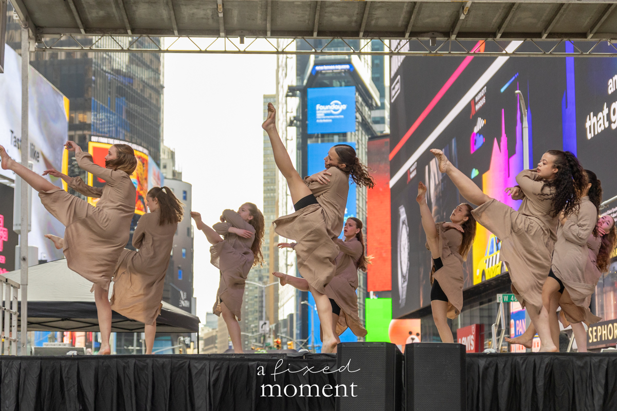 Project Dance group in neutral costumes high kicks