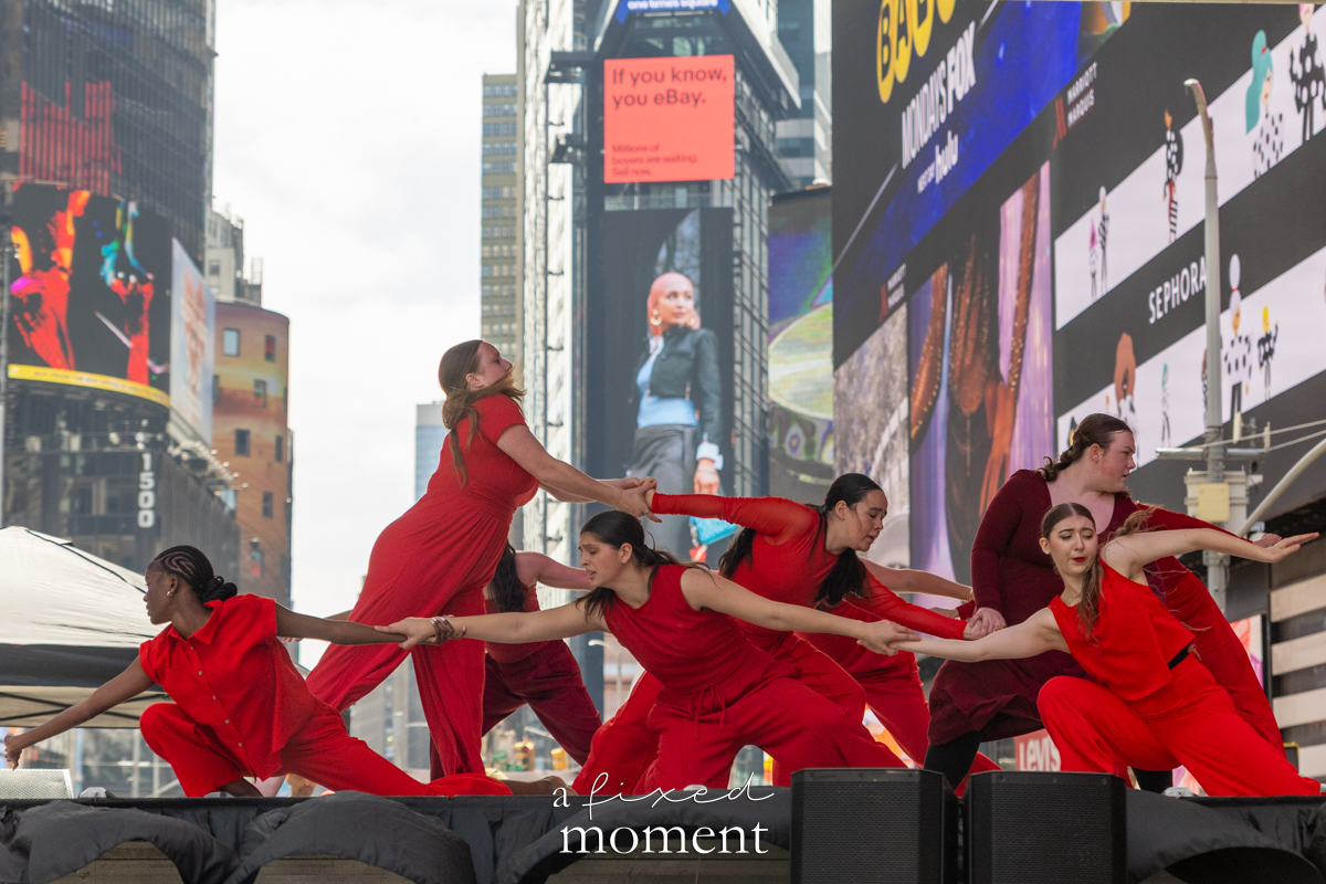 Project Dance group in red costumes linked formation