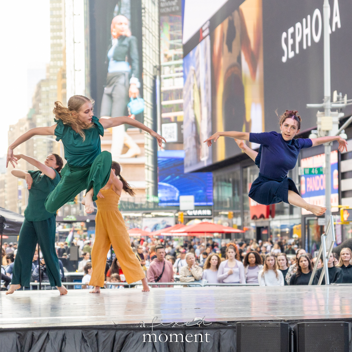 Project Dance midair leap in green and blue costumes