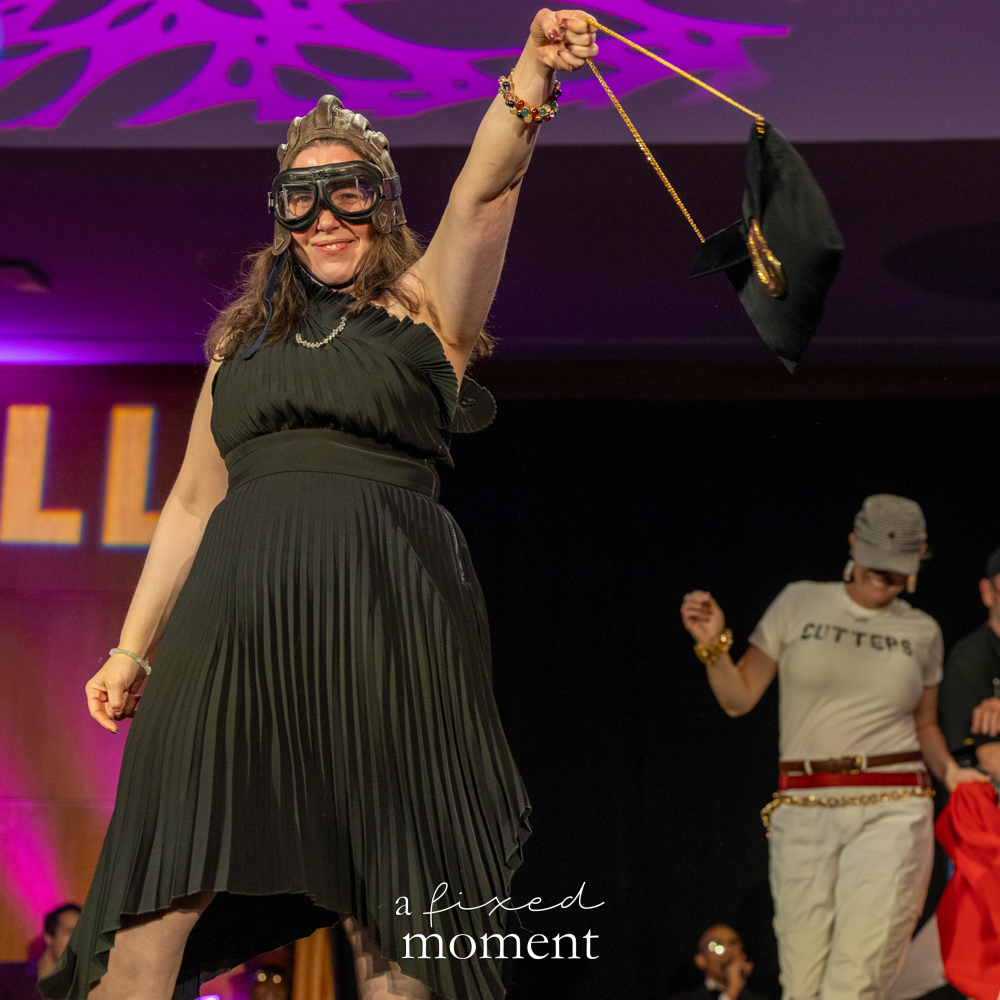 Participant in a black pleated dress and goggles on the runway at Brooklyn's 2026 People's Ball