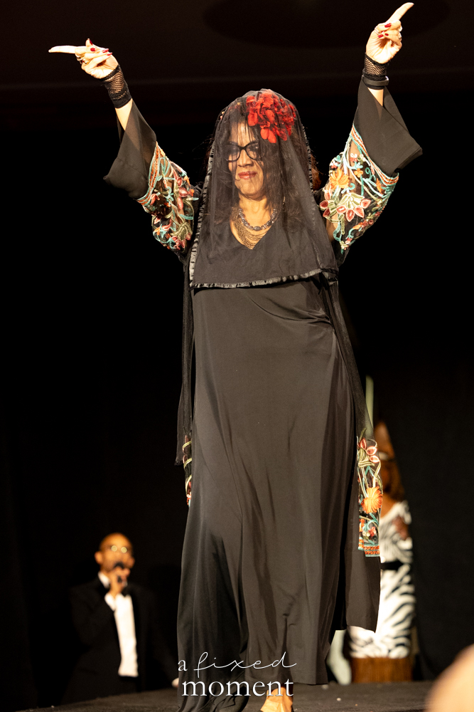 Participant in a black veil and embroidered sleeves on the runway at Brooklyn's 2026 People's Ball
