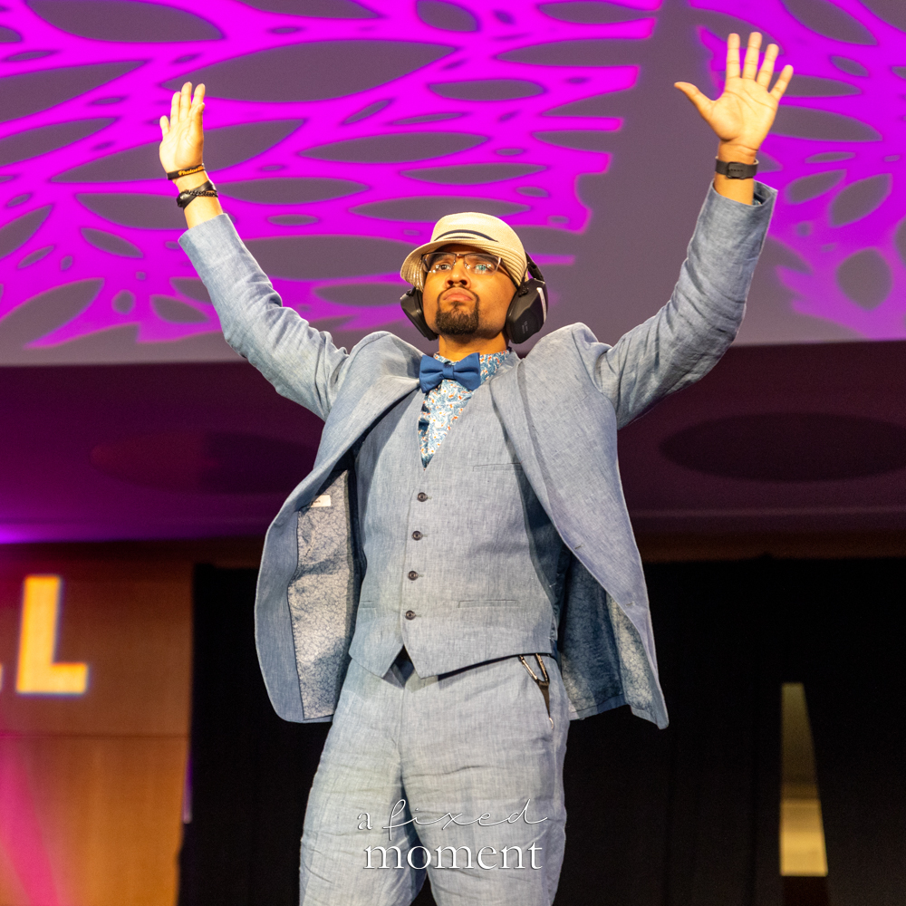 Participant in a blue suit and headphones poses on the runway at Brooklyn's 2026 People's Ball