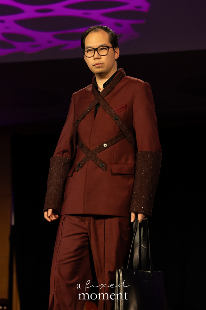 Participant in a burgundy tailored runway look at Brooklyn's 2026 People's Ball