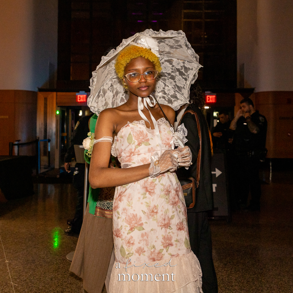 @chessey.cakes poses with a floral parasol at Brooklyn's 2026 People's Ball