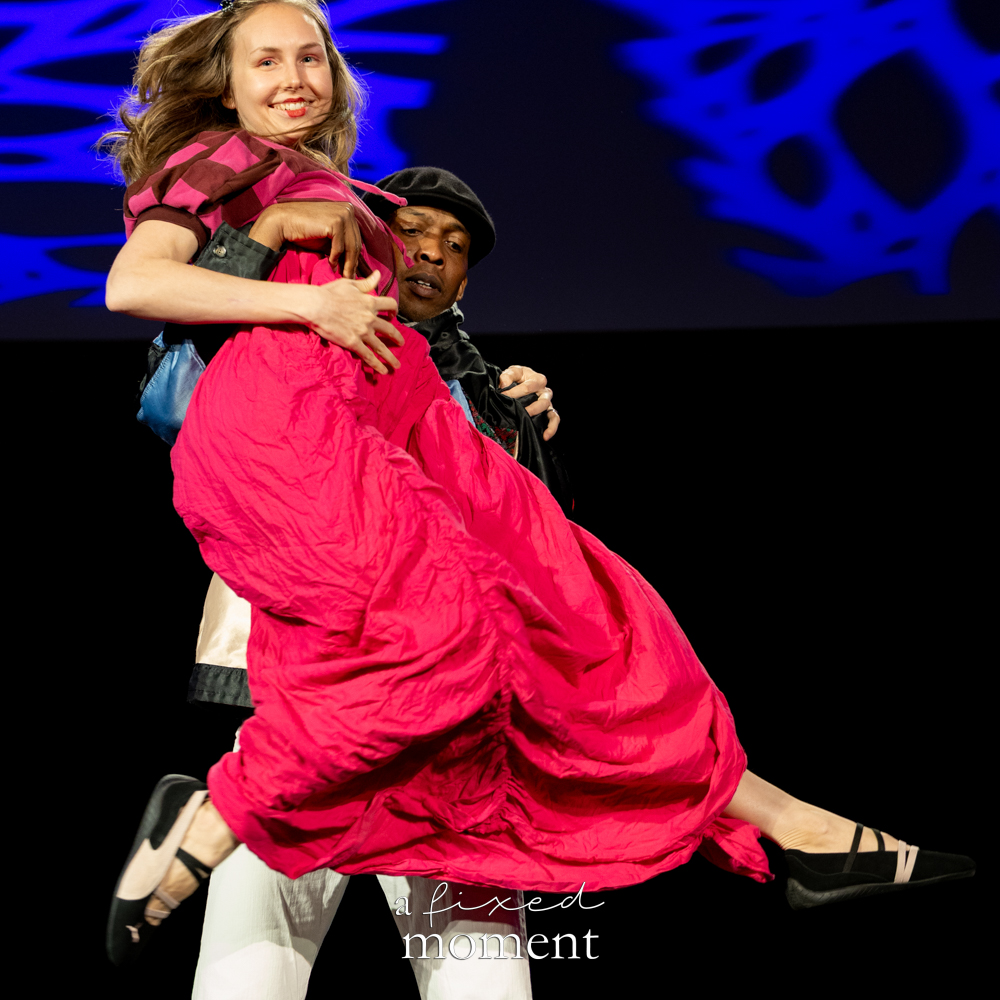 Participant in a bright pink dress is lifted during a runway performance at Brooklyn's 2026 People's Ball