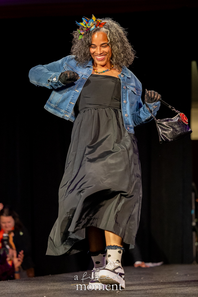 Participant in a denim jacket and black dress on the runway at Brooklyn's 2026 People's Ball