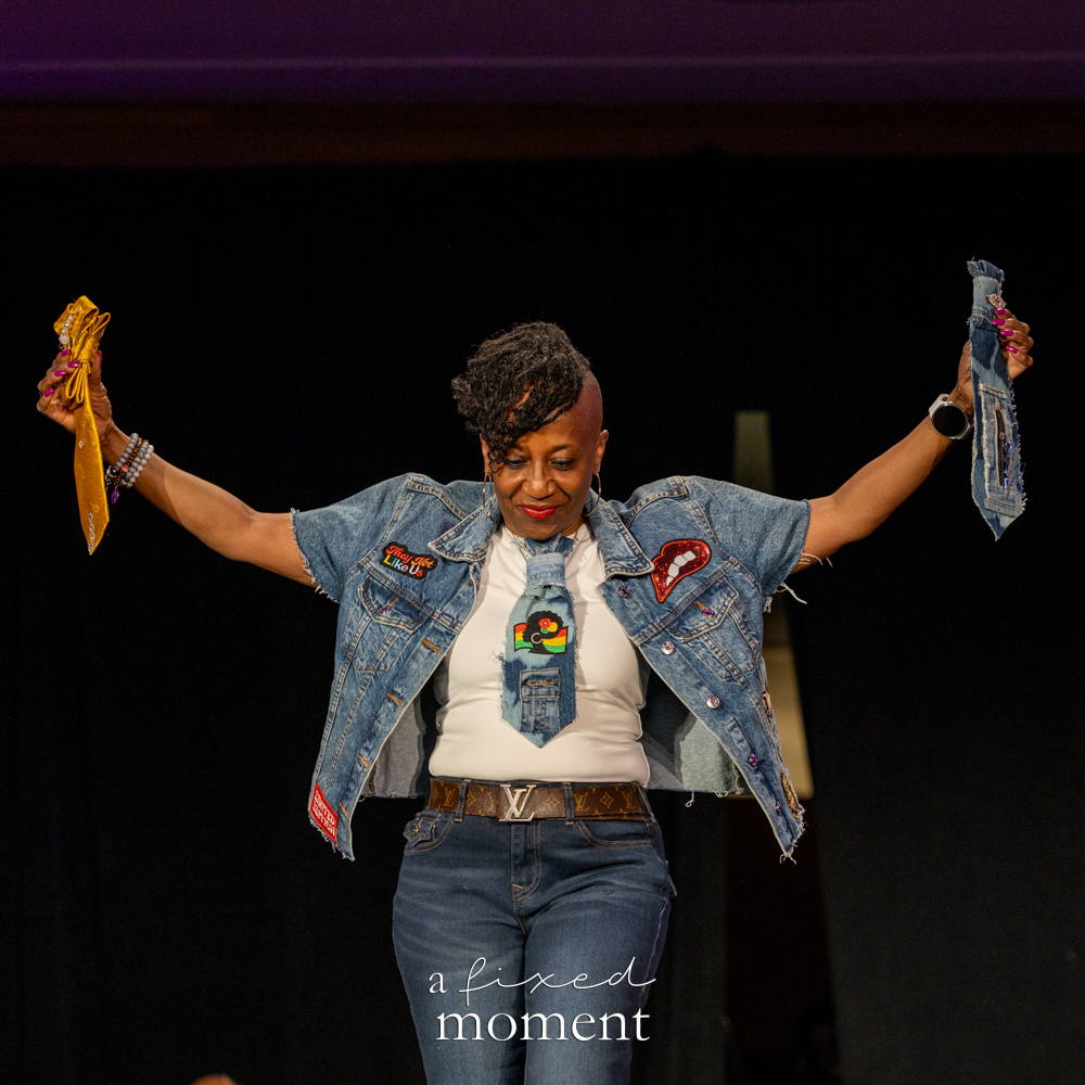 Participant in denim raises their arms on the runway at Brooklyn's 2026 People's Ball