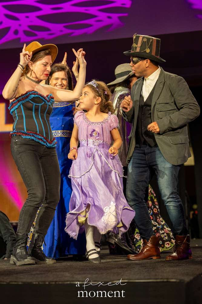 Family group with a purple dress walks the runway at Brooklyn's 2026 People's Ball