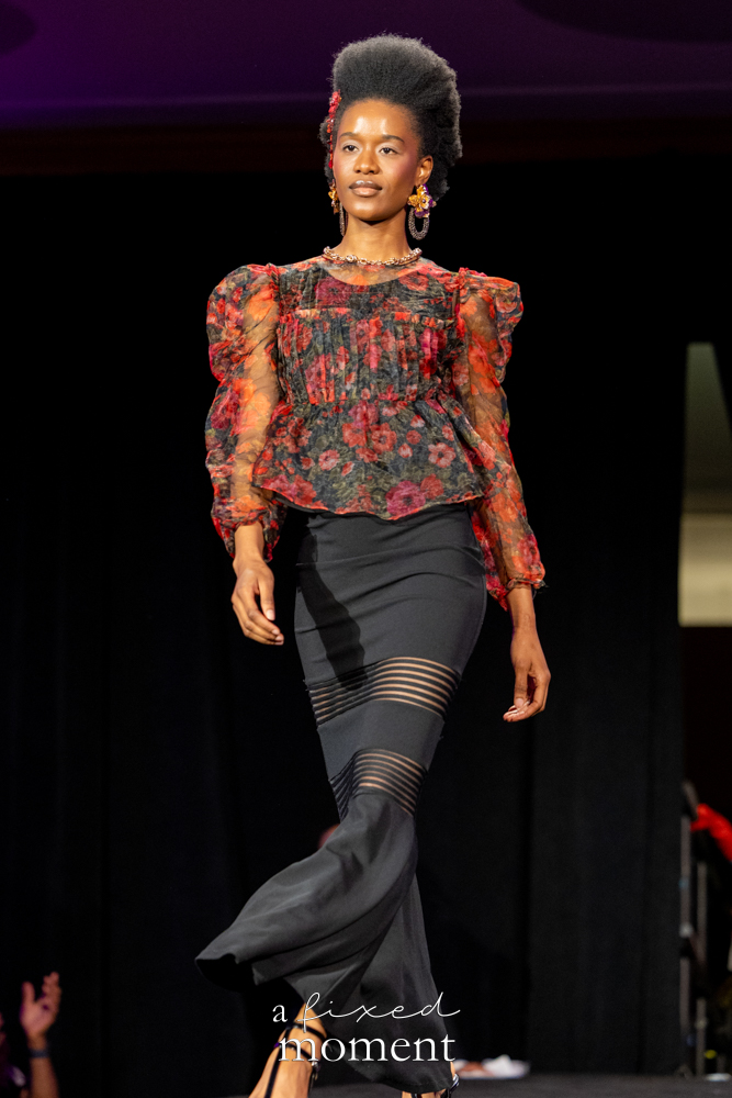 Participant in a floral sheer top and black skirt runway look at Brooklyn's 2026 People's Ball