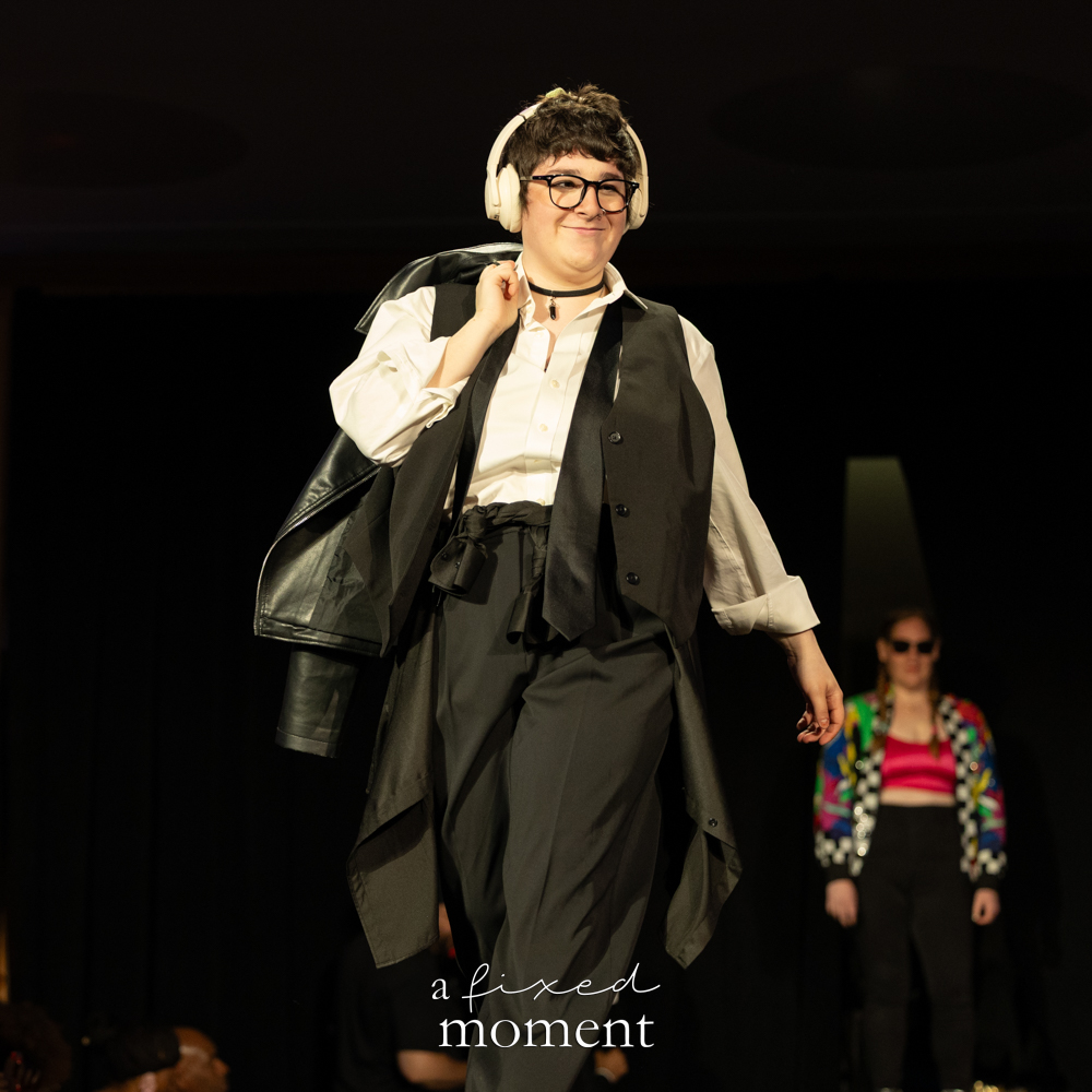 Participant in headphones and a black vest runway look at Brooklyn's 2026 People's Ball