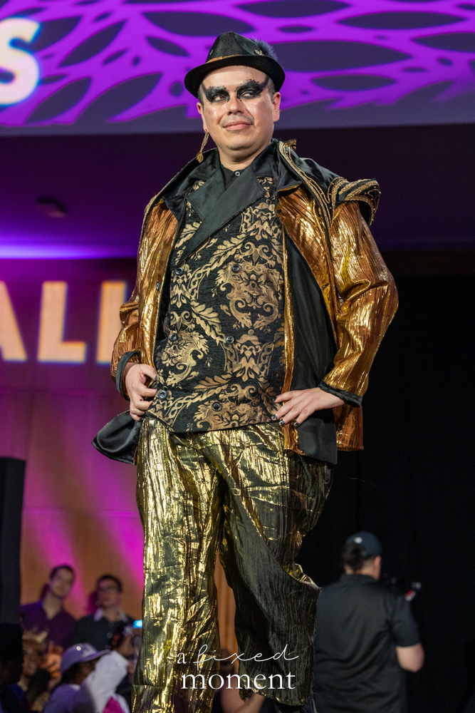 Participant in a metallic gold runway look at Brooklyn's 2026 People's Ball