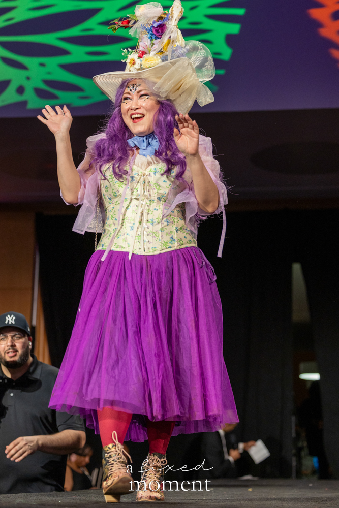 Participant in a purple tulle runway look with hat at Brooklyn's 2026 People's Ball