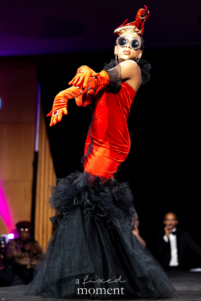 Participant in a red and black theatrical runway pose at Brooklyn's 2026 People's Ball