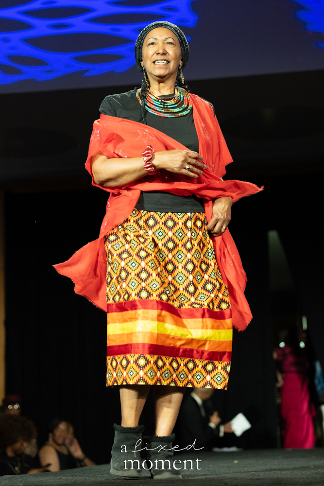 Participant in a red wrap and patterned skirt runway look at Brooklyn's 2026 People's Ball