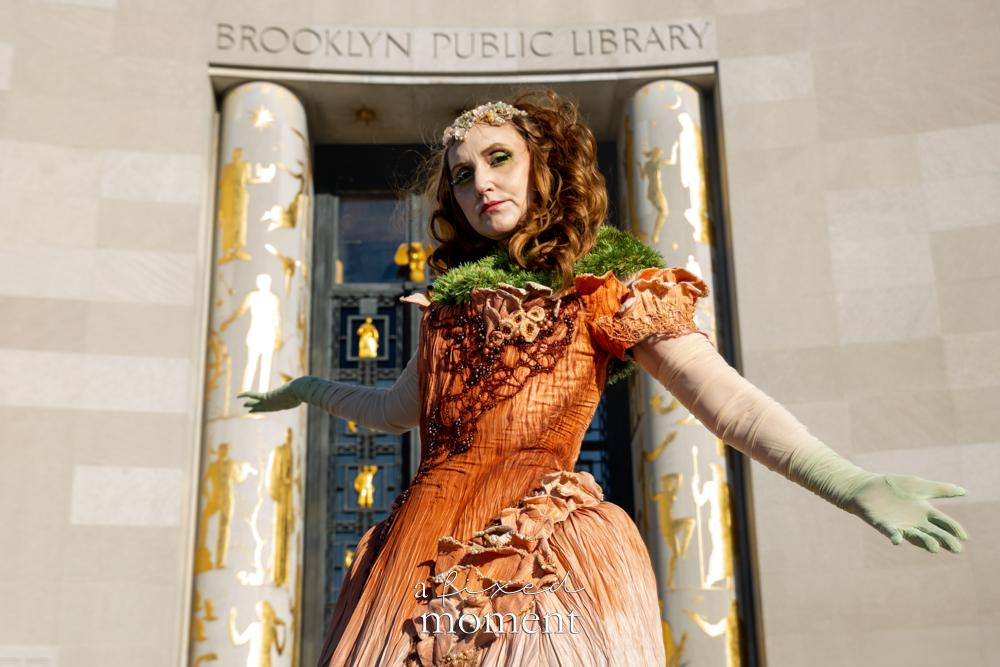 @saynotoscrunchies poses near the Brooklyn Public Library entrance in a botanical gown at Brooklyn's 2026 People's Ball
