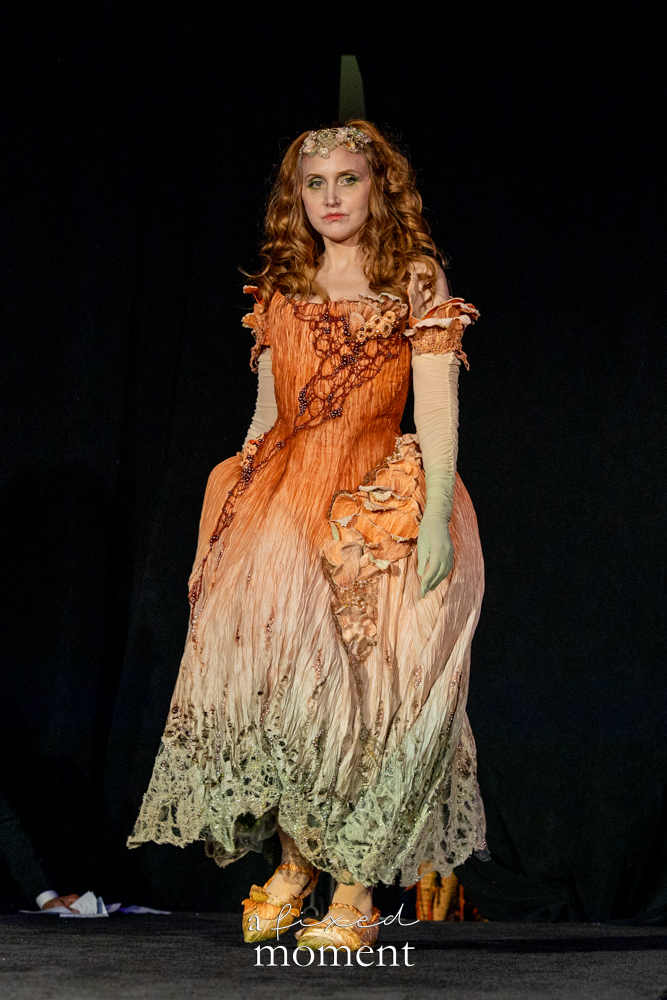 Corrie M., known as @saynotoscrunchies, walks the runway in a botanical mushroom-inspired gown at Brooklyn's 2026 People's Ball