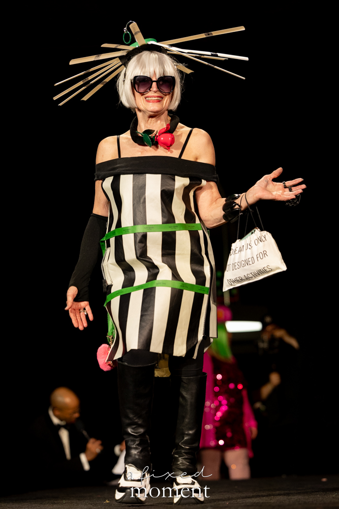 Participant in a striped sculptural headpiece runway look at Brooklyn's 2026 People's Ball