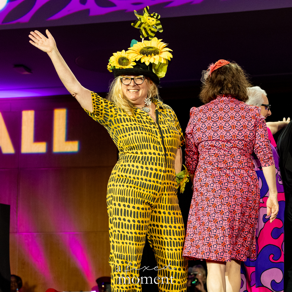 Participant in a sunflower hat and yellow runway look at Brooklyn's 2026 People's Ball