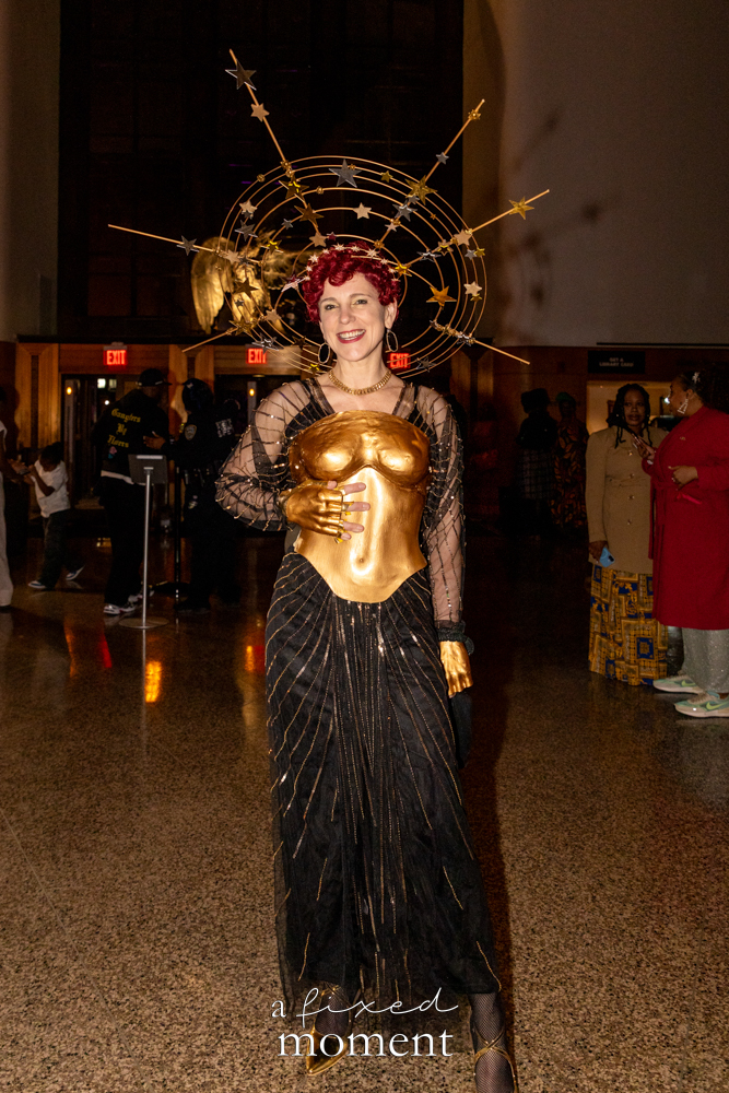 @ugretchen poses in a gold celestial look with starburst headpiece at Brooklyn's 2026 People's Ball