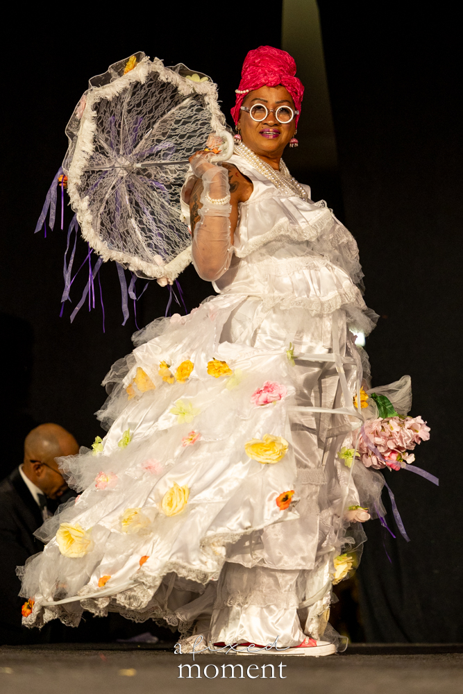 Participant with a white floral parasol on the runway at Brooklyn's 2026 People's Ball
