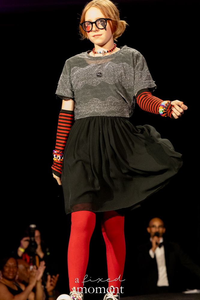 Young participant in red tights on the runway at Brooklyn's 2026 People's Ball