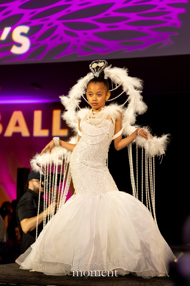 Young participant in a white pearl and feather runway look at Brooklyn's 2026 People's Ball