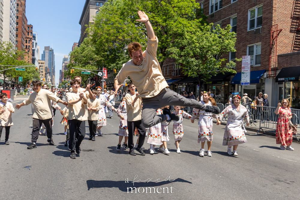 @club_kaleidoscope folk dancer leaps during Dance Parade NYC 2026