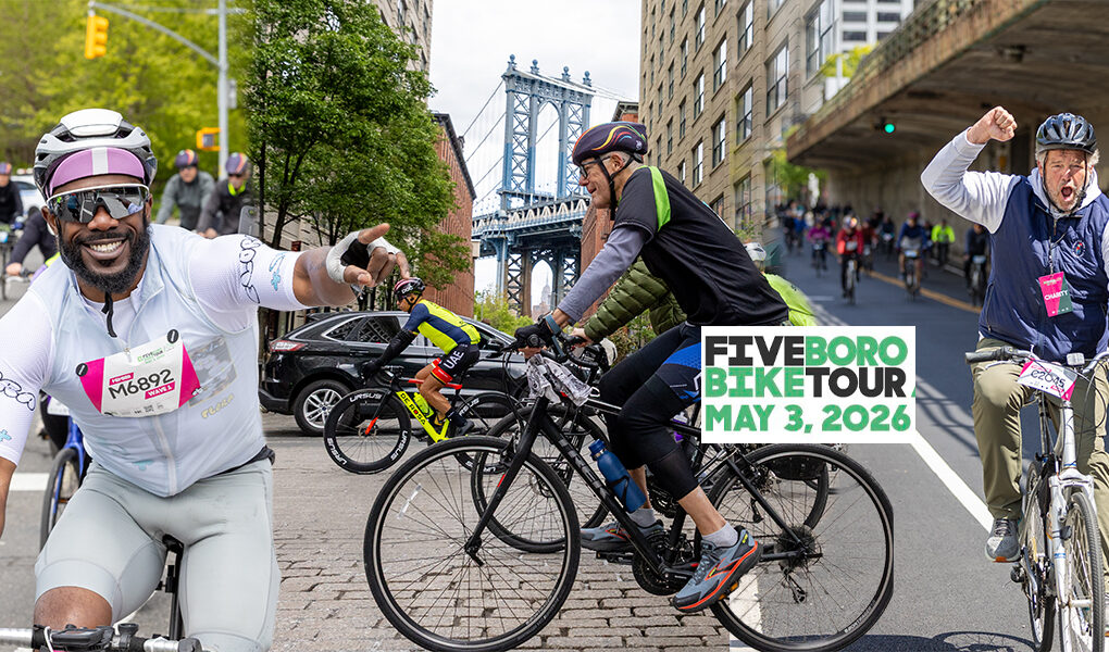 Cyclists ride through New York City during the TD Five Boro Bike Tour on May 3, 2026, with riders pointing, cheering, and celebrating along the route