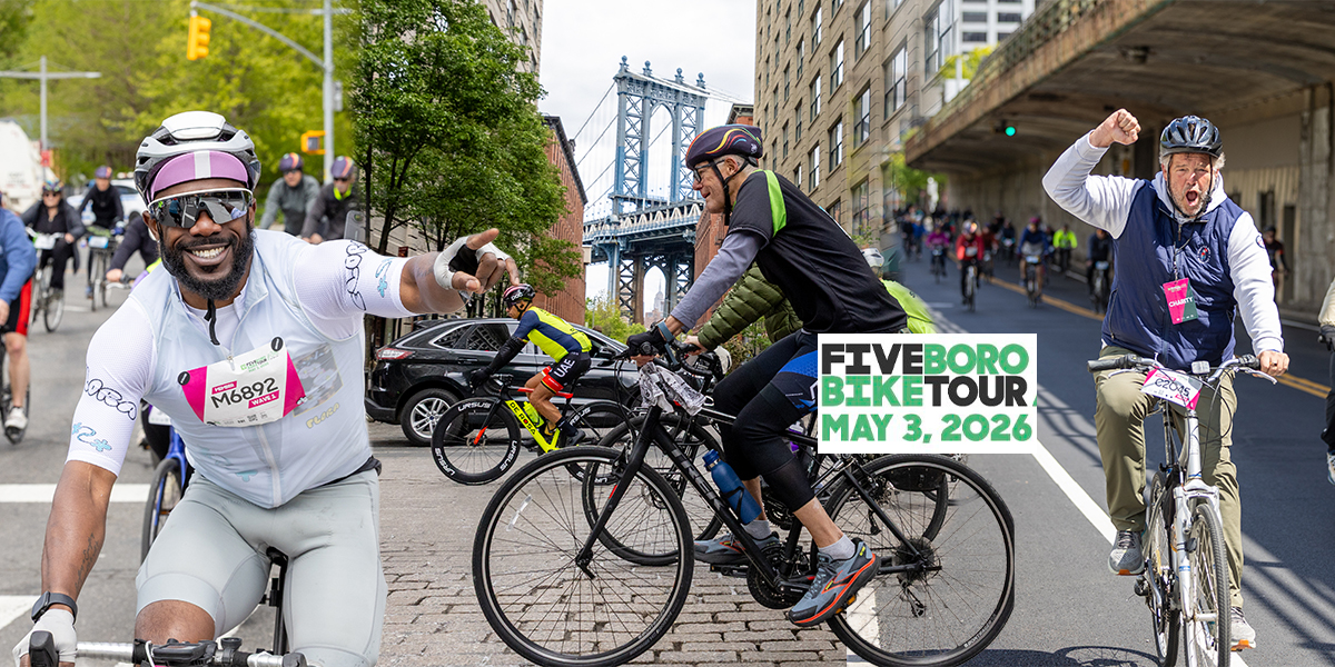 Cyclists ride through New York City during the TD Five Boro Bike Tour on May 3, 2026, with riders pointing, cheering, and celebrating along the route