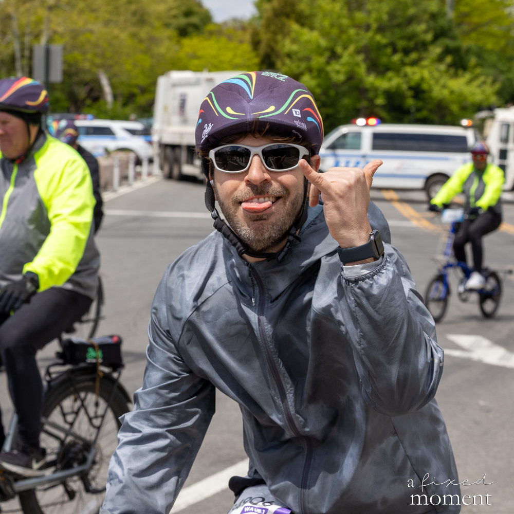 Close-up of a cyclist making a hand gesture during the 2026 Five Boro Bike Tour
