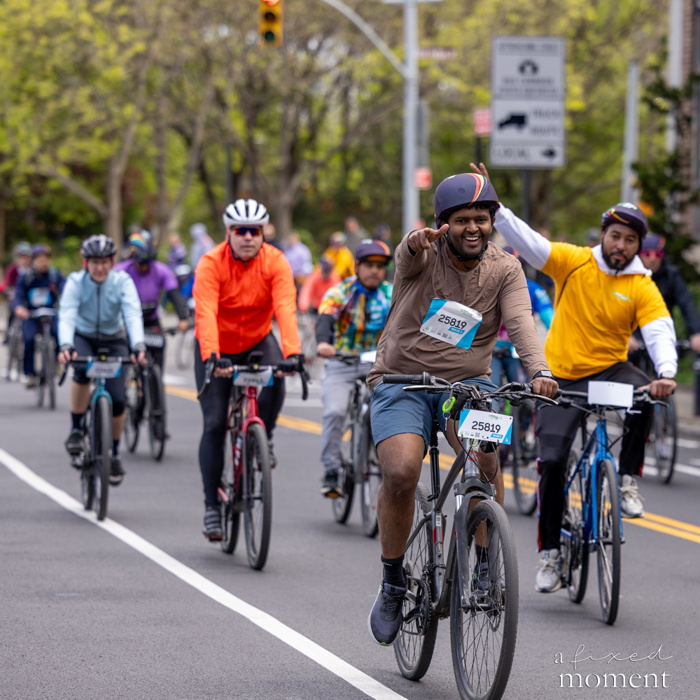 Cyclist points ahead during a group ride at the 2026 Five Boro Bike Tour