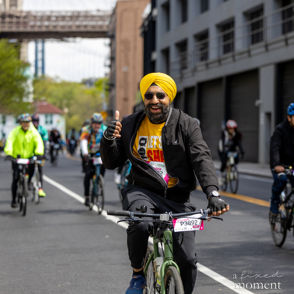 Cyclist in a yellow turban gives a thumbs up during the Five Boro Bike Tour