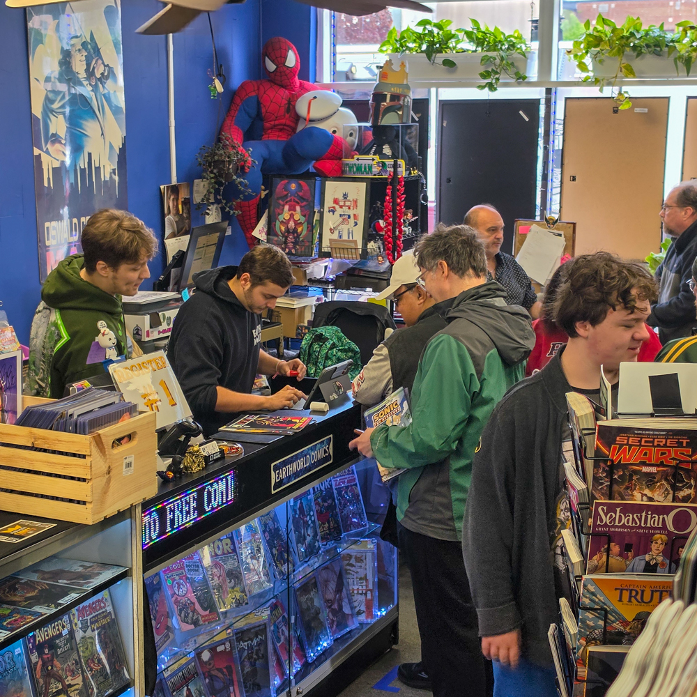 Customers gather near the checkout counter at Earthworld Comics during Free Comic Book Day in Albany, New York