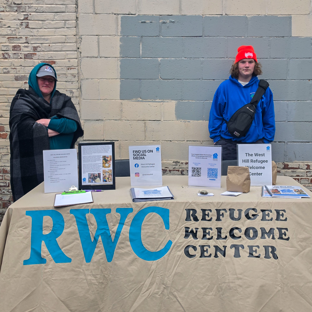 West Hill Refugee Welcome Center table during Free Comic Book Day at Earthworld Comics in Albany, New York