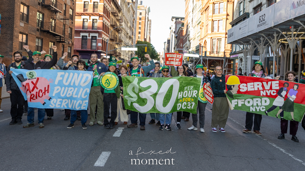 DC37 marchers carry public service and $30 signs