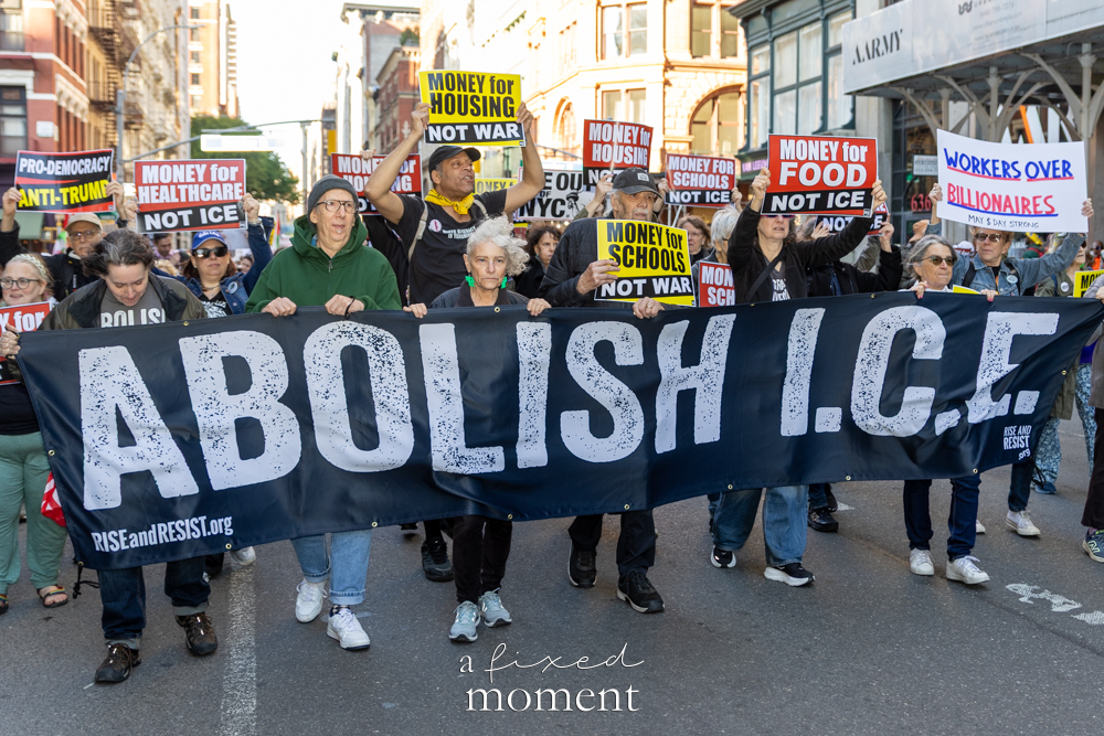 Marchers carry an Abolish ICE banner