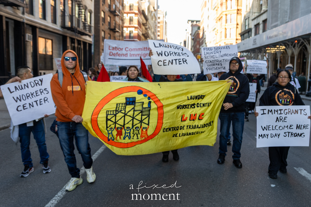 Laundry Workers Center members carry a banner during the May Day Protest in New York City on May 1, 2026