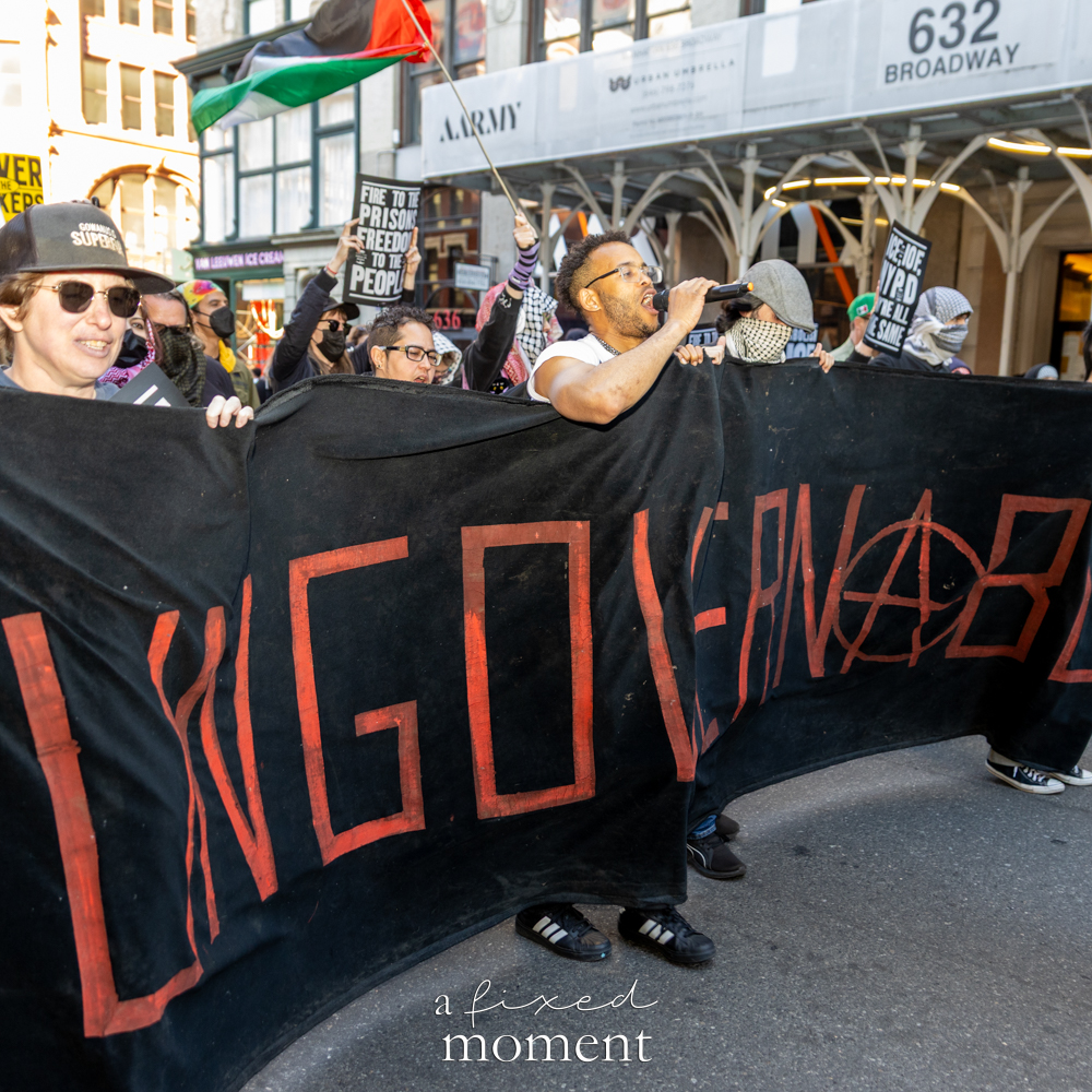 Marchers carry a Long Live banner with a Palestinian flag
