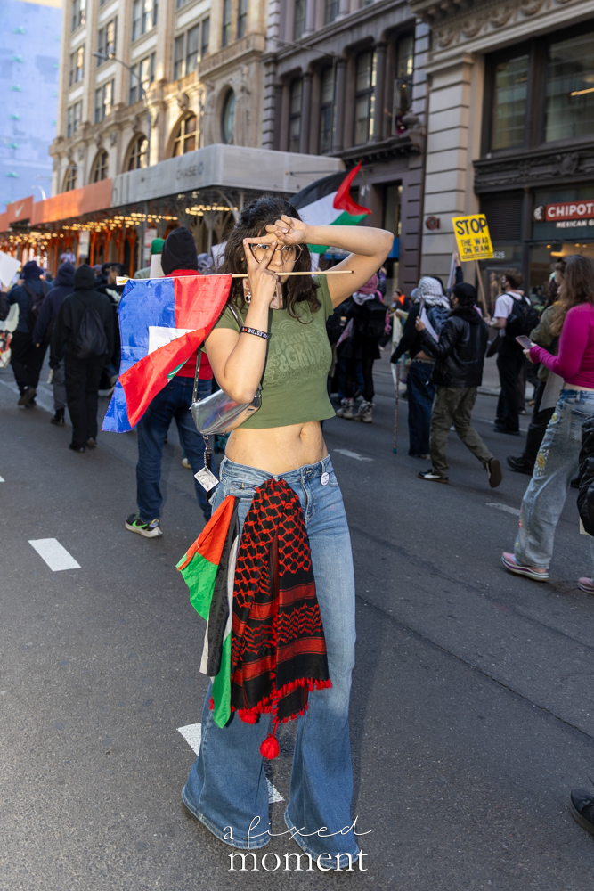 A participant carries a Palestinian flag during the May Day Protest