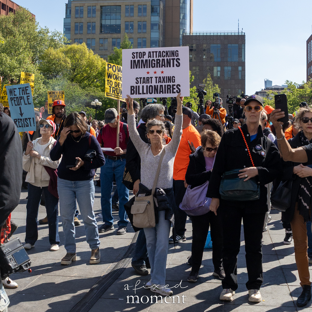 A protester holds a Stop Attacking Immigrants sign