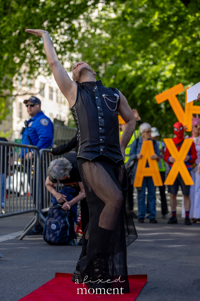 Funkybunnynyc performs on a small red carpet during the Rise and Resist protest outside the Met Gala