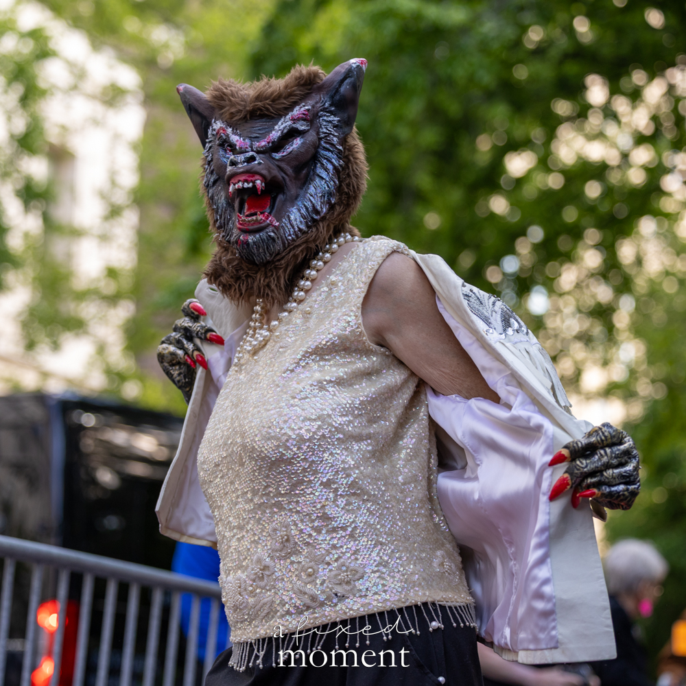 Masked monster costume with sequined details at the Resistance Red Carpet protest outside the Met Gala