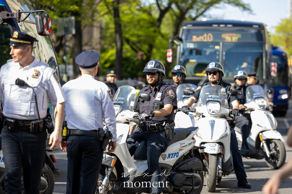 NYPD motorcycle officers and security presence outside the Met Gala during the Rise and Resist protest