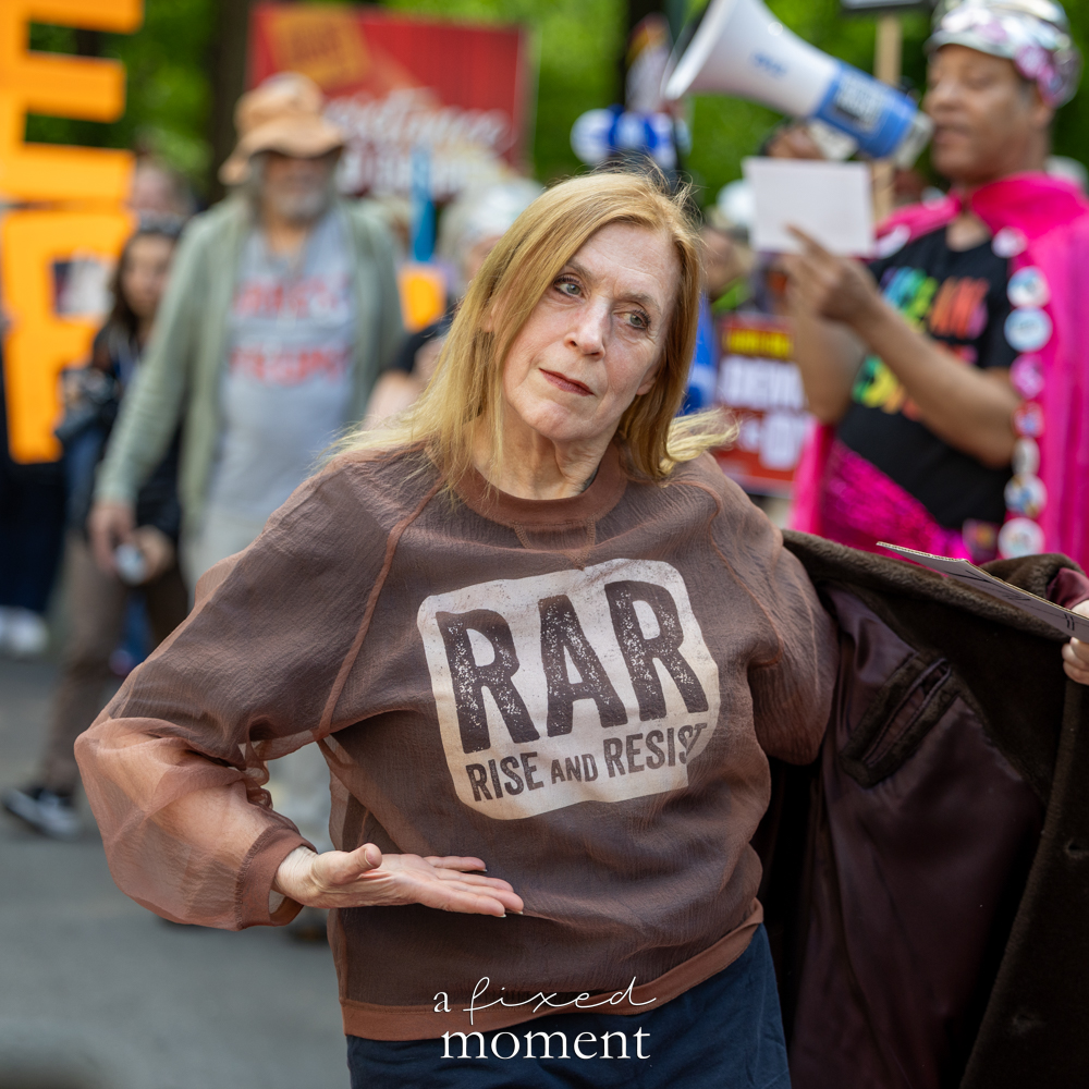 Rise and Resist performer gestures during the Resistance Red Carpet protest outside the Met Gala