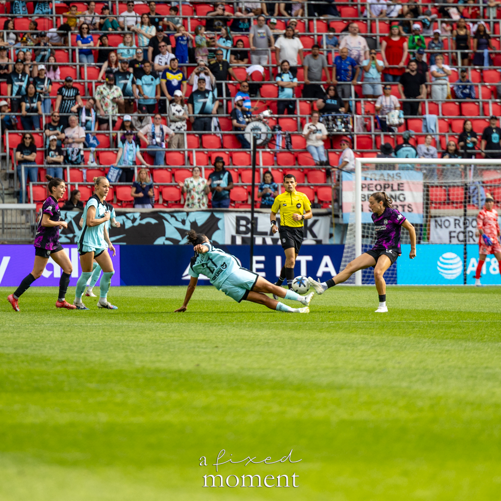 Gotham FC @gothamfc player sliding on the field while a Houston Dash @houstondash player reaches for the ball near the goal.