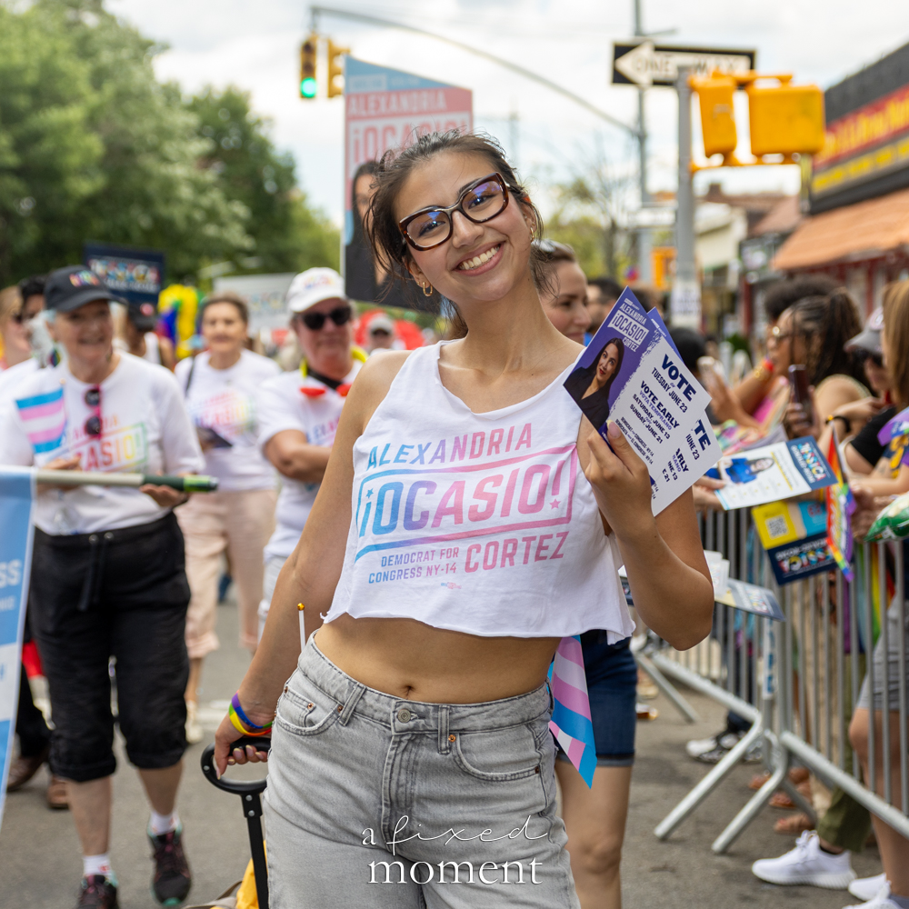 An Alexandria Ocasio-Cortez campaign supporter appears at Queens Pride.