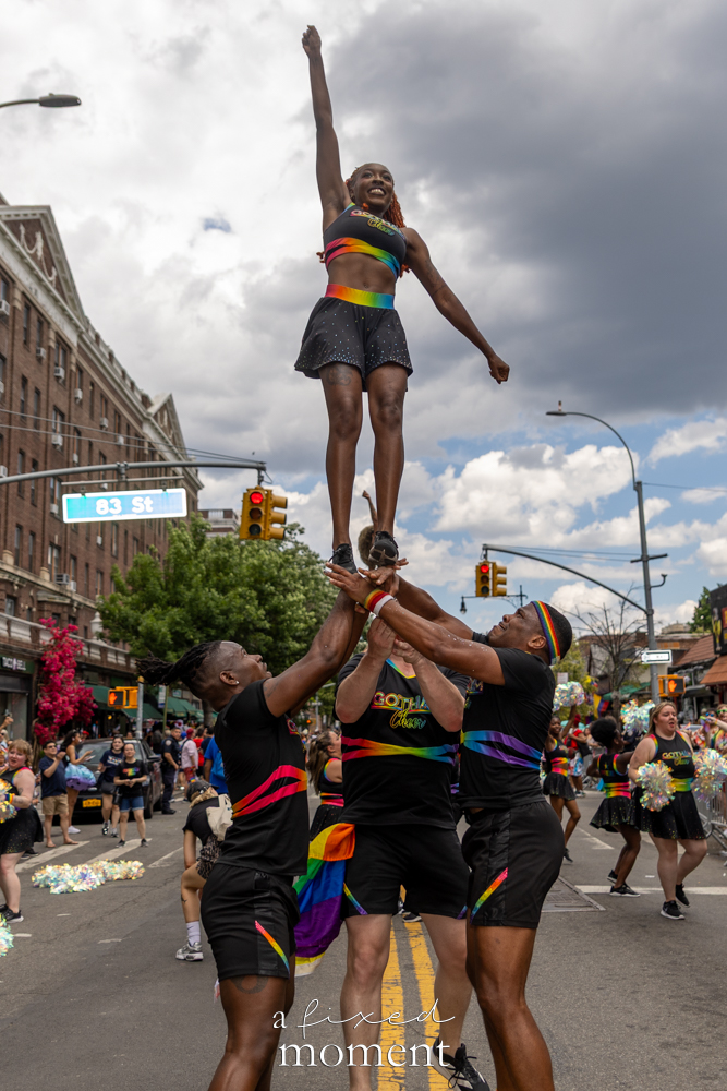 Gotham Cheer Team performs an elevated stunt during the New Queens Pride Parade in Jackson Heights, Queens.
