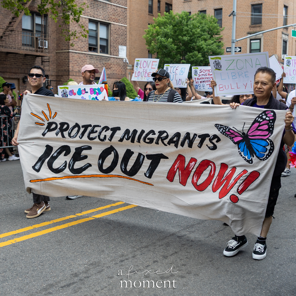 Marchers carry a Protect Migrants ICE Out Now banner during the New Queens Pride Parade in Jackson Heights.